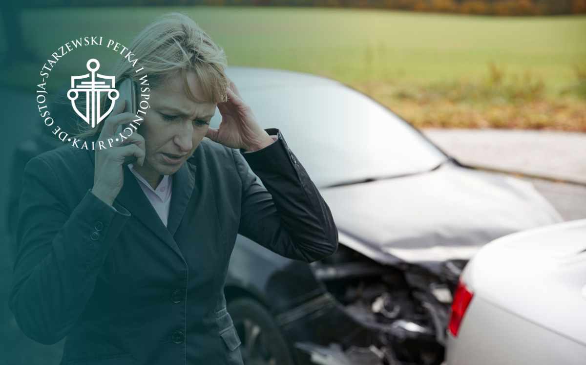 Businesswoman on the phone after a car crash, with a damaged vehicle in the background and a watermark logo on the left.