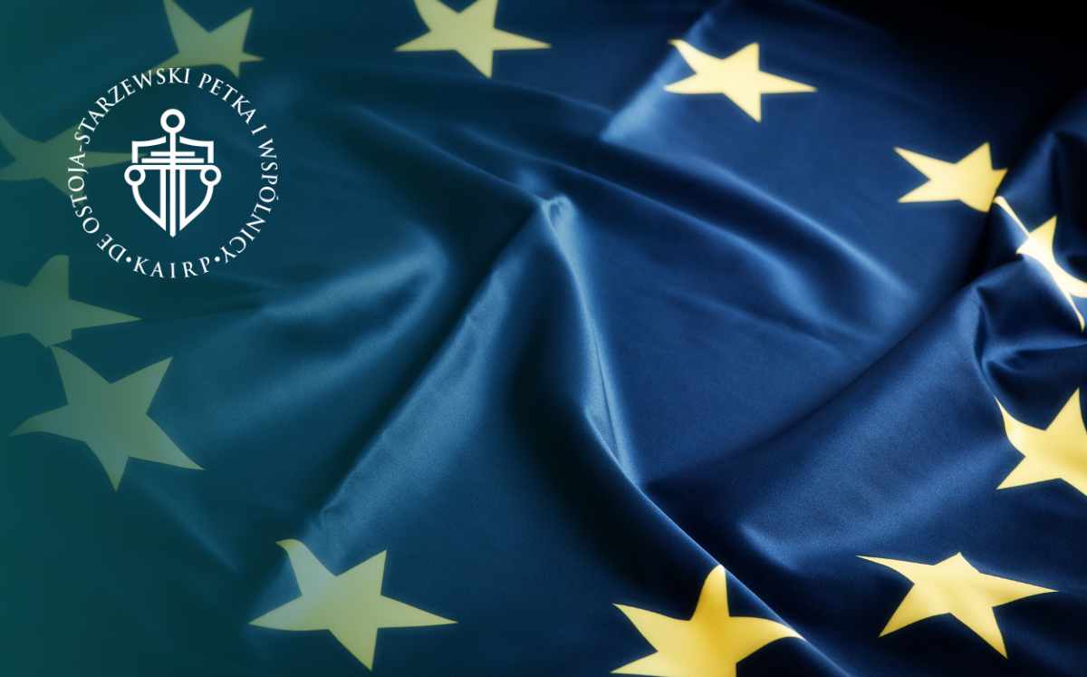 Blue European Union flag with yellow stars and a circular emblem in the top-left corner.