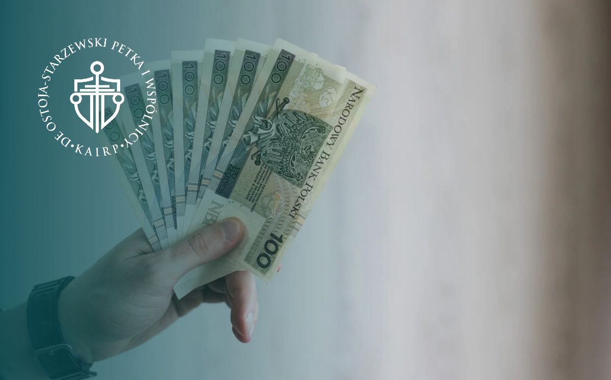 Osoba trzyma w dłoni plik banknotów 100 zł